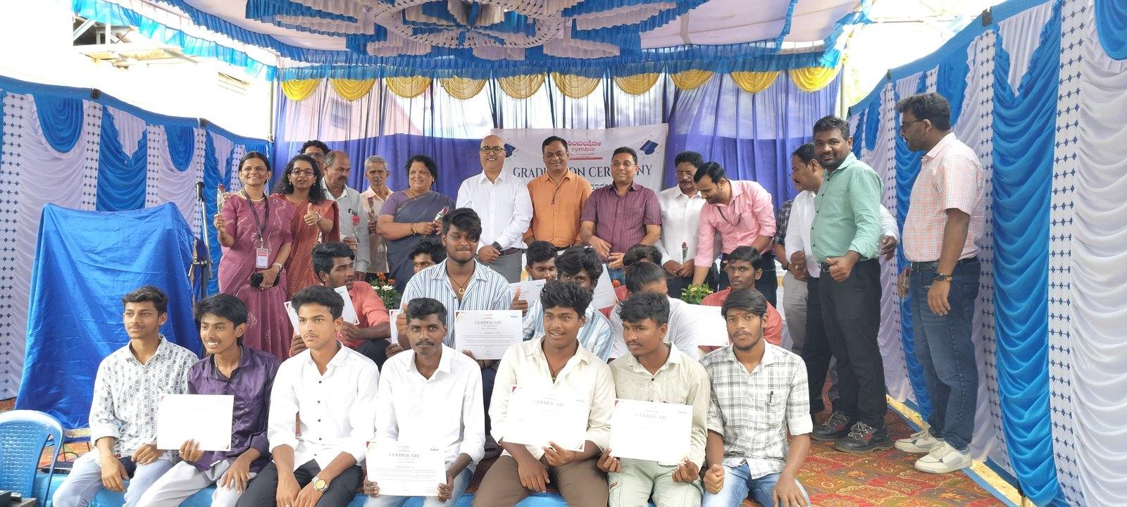 Students receiving certificates at a Symbio-supported programme