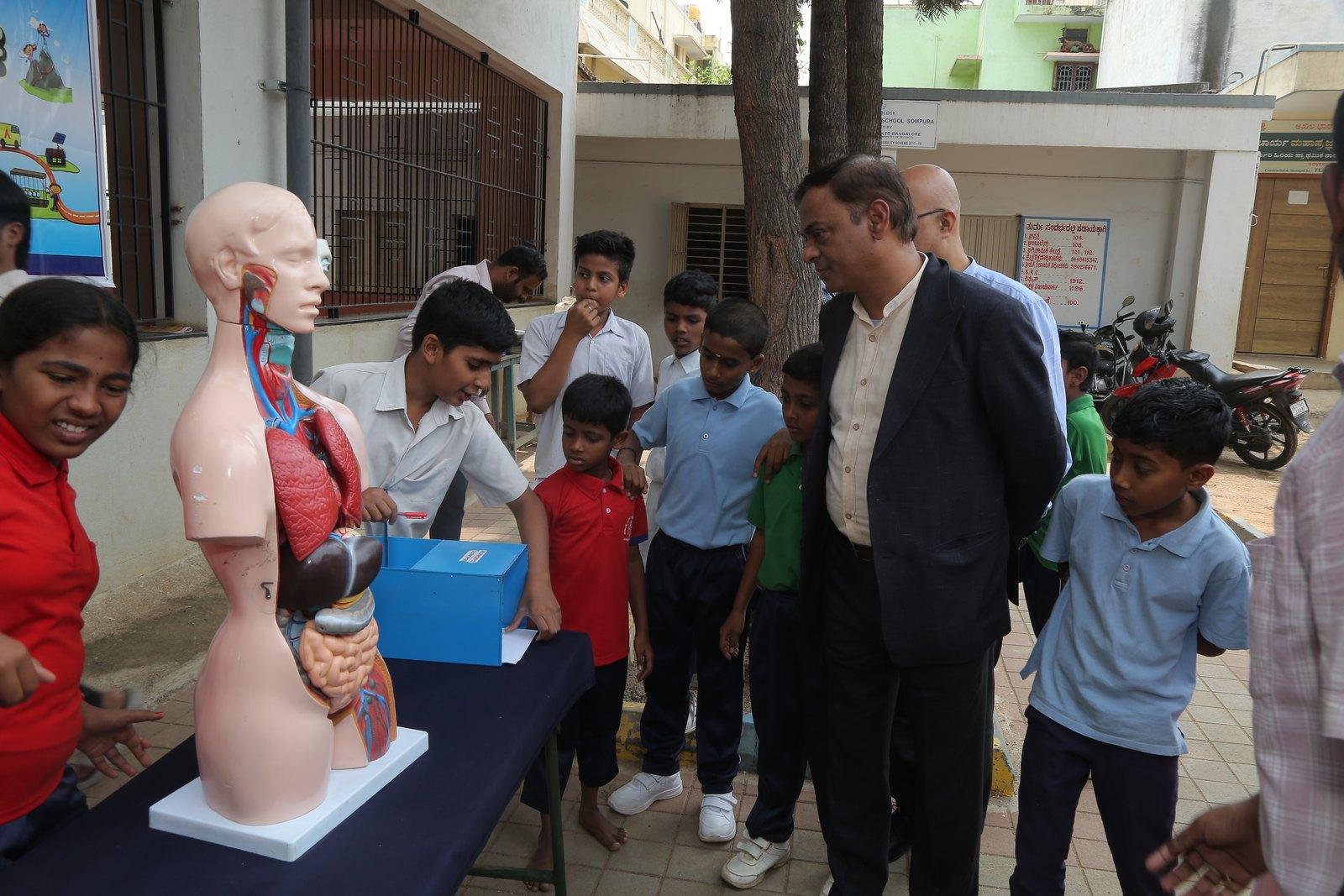 Students exploring an anatomical model at a Symbio-supported Agastya session